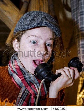 Teenage girl speaking by old vintage telephone, close-up portrait