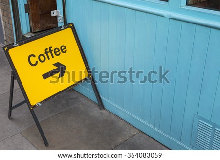 A sign displaying the direction for people who need a coffee.