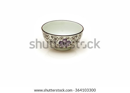 Single hand painted oriental soup bowl on white background with reflection. A bowl is a round, open-top container used in many cultures to serve hot and cold food.