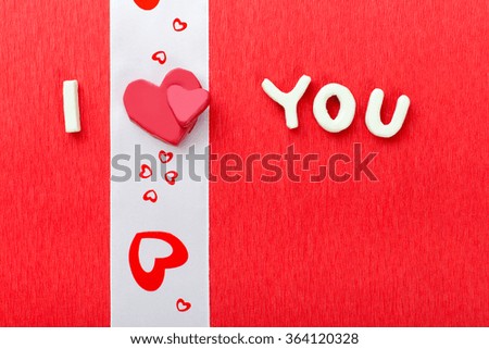 I Love You, ribbon with hearts drawn and plasticine heart used as a symbol of love in this Valentines message