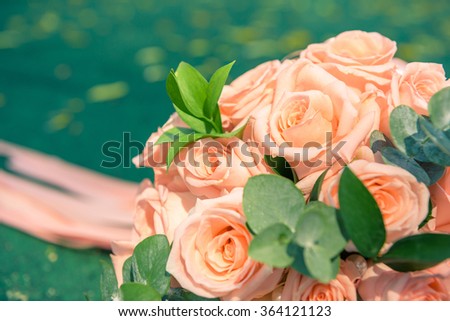 picture of a wedding bouquet , Wedding bouquet of roses lying on green background