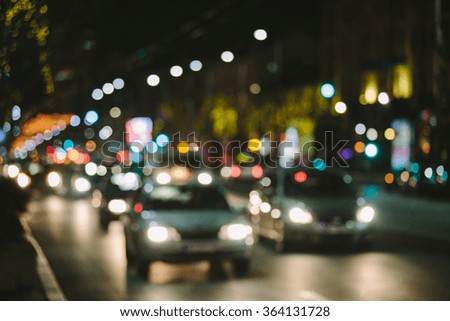 Blurred background. Night city lights blur. Toned photo.
