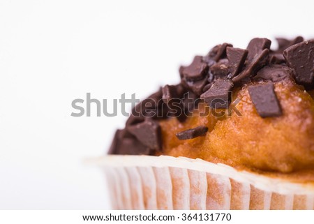 Yummy fresh appetizing bakery dessert muffin decorated by chocolate chips homemade pastry diet for lunch with sugar and fat calories closeup isolated on white background, horizontal picture 