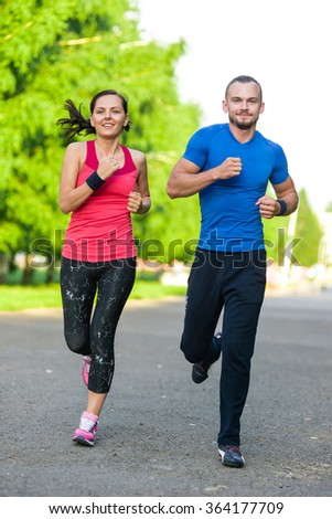 Runners training outdoors working out. City running couple jogging outside. 
