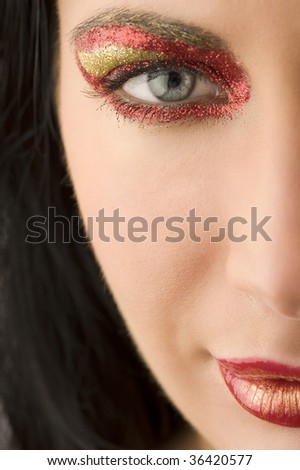 half face portrait of a beautiful woman with artistic make-up on her face
