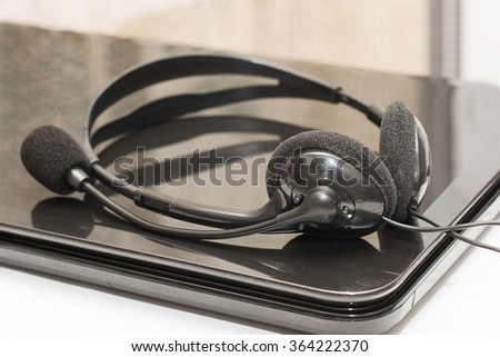 headset with microphone lie on a laptop