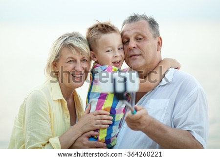 Grandparents and grandson making phone selfie