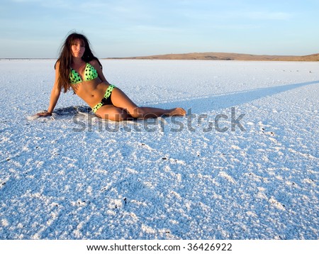 Girl on snowy salt surface.