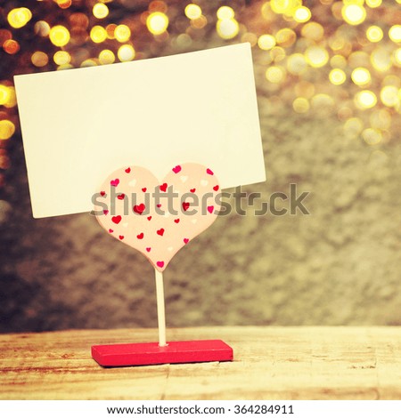 Heart with paper on wooden background