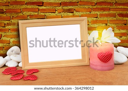 picture frame and candle with brick wall background