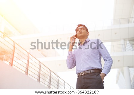 indian business male on a phone conversation outdoor