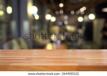 Empty wooden table and blurred cafe background, product display,montage 