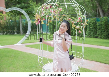 young woman tourist with camera in garden