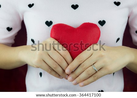 red heart in hands with heart gesture, valentine's concept