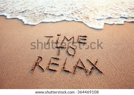 time to relax, concept written on sandy beach Royalty-Free Stock Photo #364469108