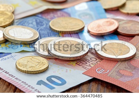 Money Euro banknotes and coins on wooden table