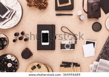 Photographers Desktop with Scrapbook, Smartphone, Cameras. Photographers Working Place.