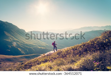Man Traveler with backpack hiking Travel Lifestyle concept beautiful mountains landscape on background Summer vacations activity outdoor