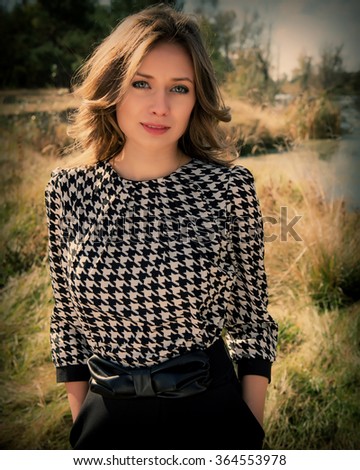portrait of a beautiful young woman on a background of the river