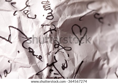 crumpled letter with words of love and heart