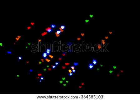 Color Bokeh on a dark background with hearts