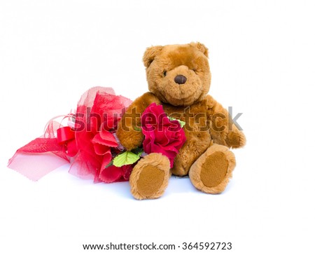 The teddy Bear with red rose sitting on white background.