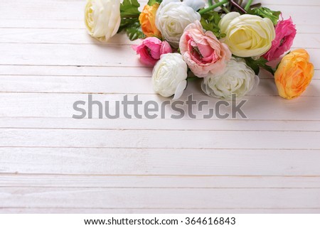 Border from flowers  on white wooden background. Selective focus. Place for text. 