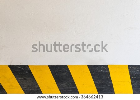 White wall and yellow black stripe background.