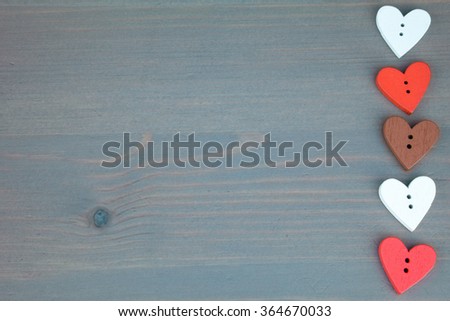 Red hearts on grey wooden background. Button love. Wooden buttons. Post card for the Valentine.