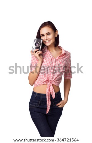 Beautiful young girl holding an old camera . modern style of clothing. old camera . White background. isolated. colored shirt. model face. film camera