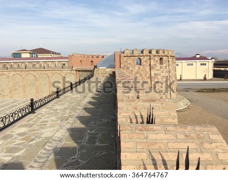 High ancient castle walls with railing