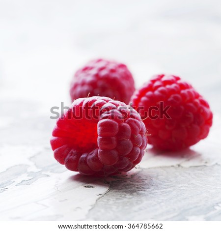 Sweet fresh raspberry on the vintage table, selective focus and square image