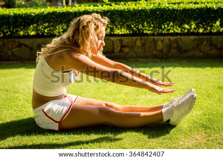 Sport and lifestyle concept - woman doing sports outdoors
