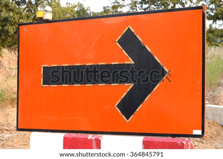 Sign direction with red background near the road