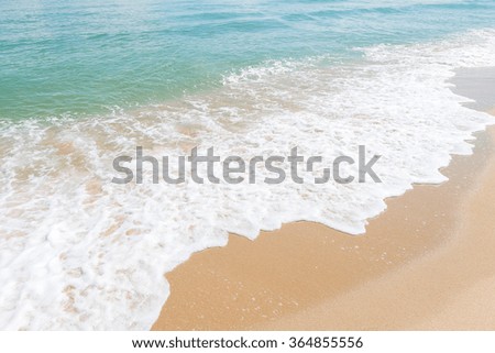 HDR shot of sea shore with wave and white sand during summer day in thailand (selective focus and white balance / color tone shift )