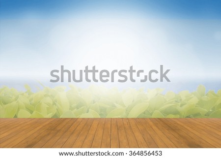 Wood table top on green bokeh abstract background - can be used for montage or display your products