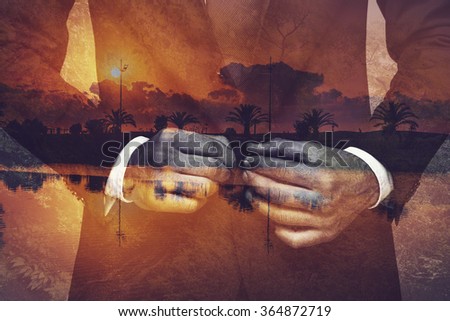 Getting ready for new day. Digitally composed picture of young businessman buttoning his jacket over the picture of landscape with palm trees