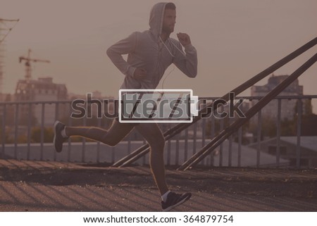 Full energy. Digitally composed picture of full charged battery symbol over picture of the jogger