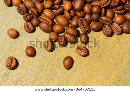 Coffee beans on wood background. Coffee on grunge wooden background