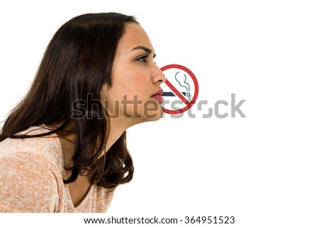 Serious woman looking away with no smoking sign over white background
