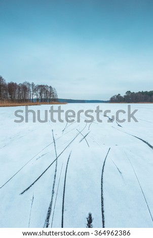 Frozen lake landscape. Beautiful lake in Poland with skate traces.