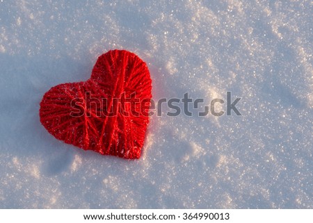Valentines Day background. Red hearat on snow