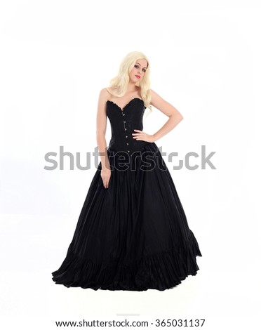 blonde haired woman wearing a long black gown with corset. isolated on white background.
