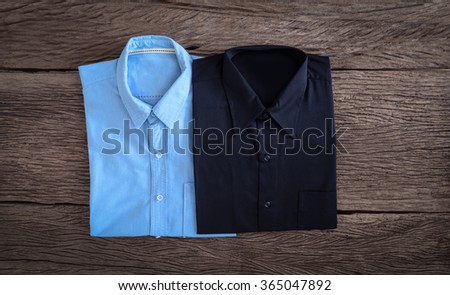 Black Shirt and Jeans shirt  on wooden background