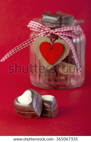 Chocolate in a jar on red background. Valentines day romantic concept.