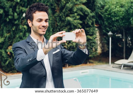 Young Businessman Taking Photos with Mobile