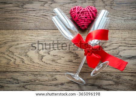 Two flutes with retro cane hearts on the wooden background