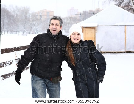 father and teen daughter on the skating ring close up smiling portrait