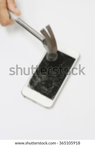 Blur of Broken mobile phone hit by hammer on white background