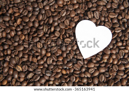 In love coffee beans, paper heart on coffee beans